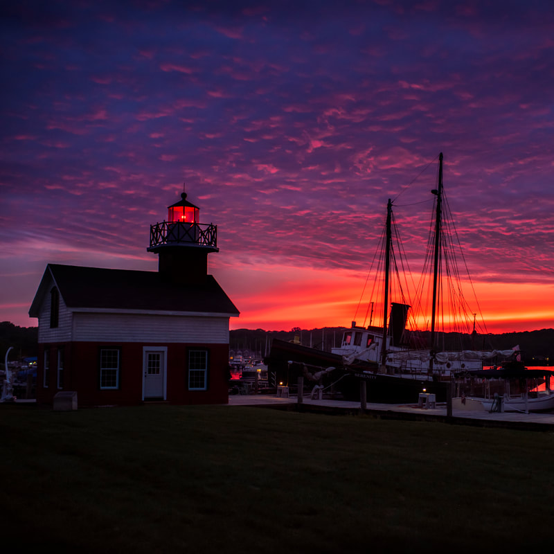 The waterfront at dusk with sailboat masts